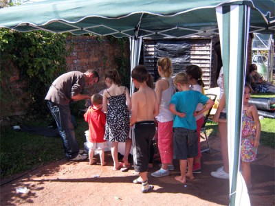 Queue for Glitter Tattoos at Cots for Tots fun-day